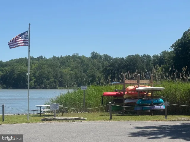 a view of lake with green space and trees in the background