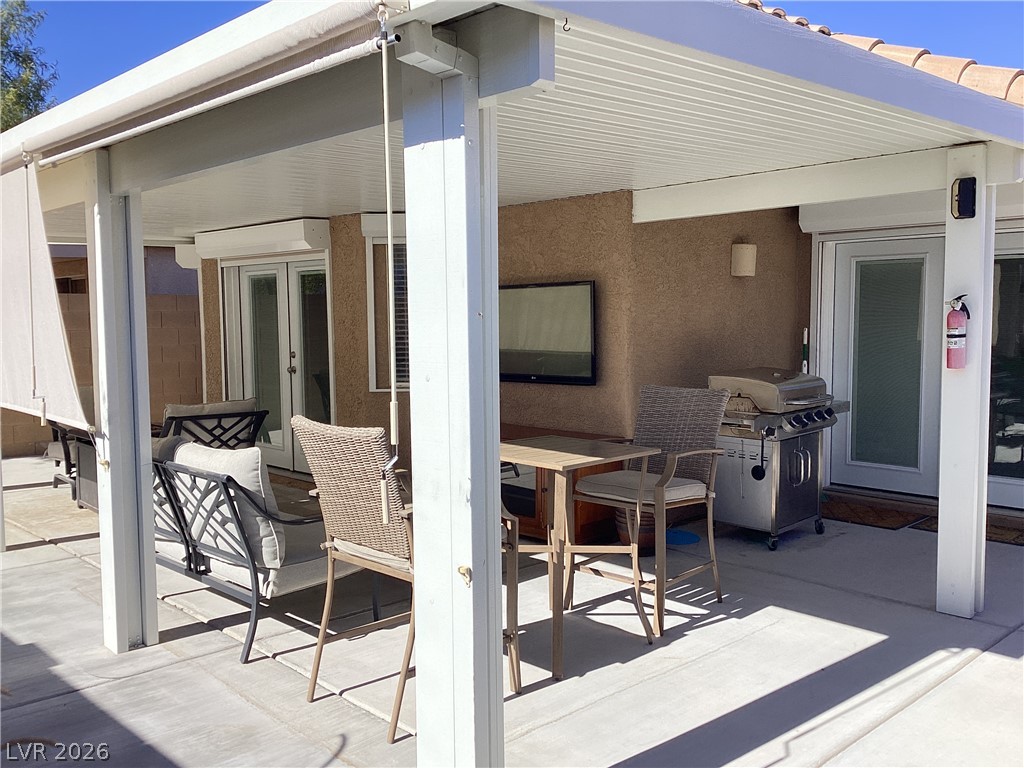 2135 Hidden Ranch Terrace Henderson, NV 89052 - Photo 23 of 27 An inviting covered patio offers a comfortable space for outdoor dining and entertaining.