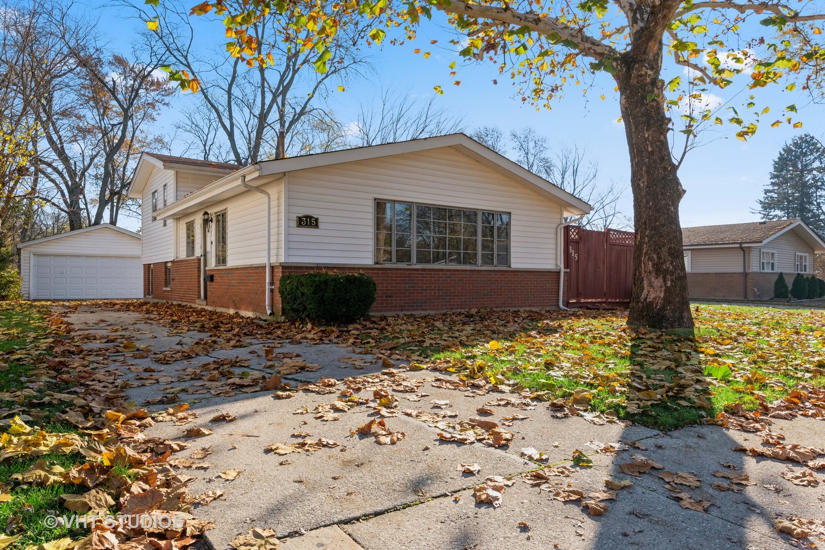 315 Springfield Street Park Forest, IL 60466 - Photo 1 of 13 a house that has a tree in front of it