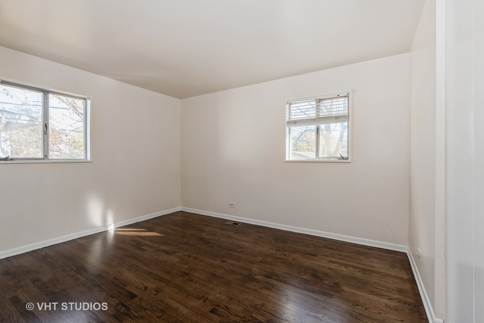 315 Springfield Street Park Forest, IL 60466 - Photo 7 of 13 an empty room with wooden floor and windows
