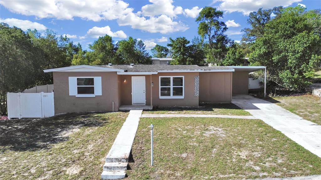 7098 Holiday Drive Spring Hill, FL 34606 - Photo 1 of 1 a view of a house with a yard
