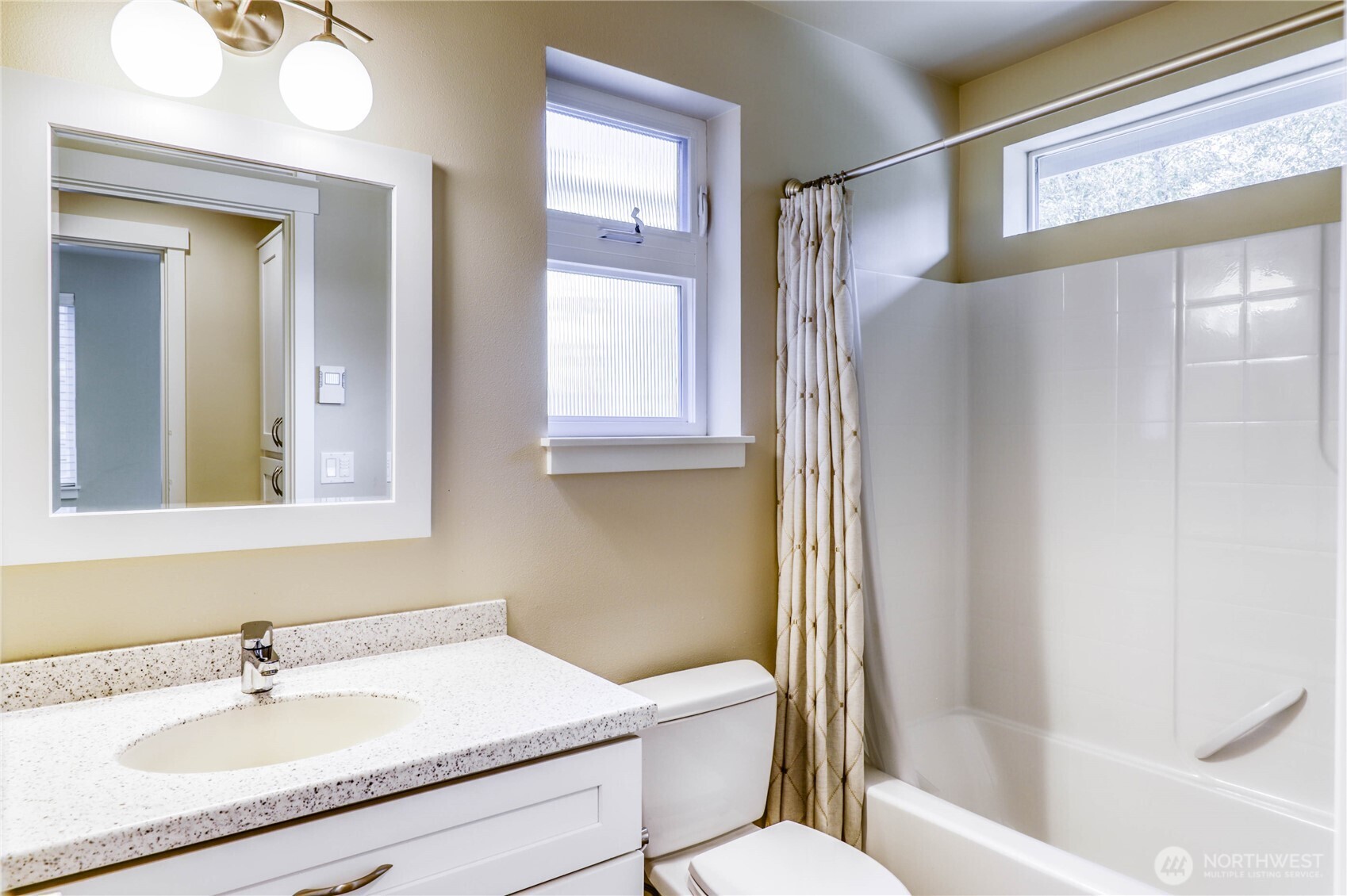 690 Wintersweet Road Northeast Bainbridge Island, WA 98110 - Photo 16 of 23 a bathroom with a sink toilet and shower