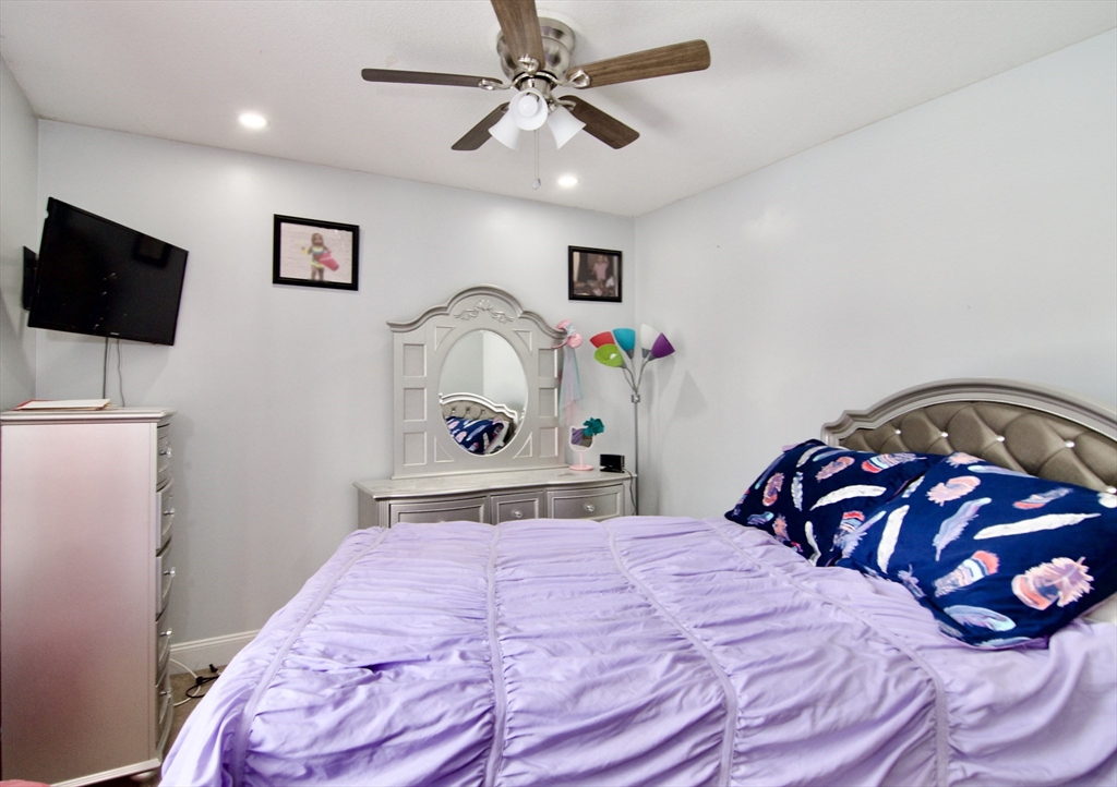 35 Anniversary Street Springfield, MA 01104 - Photo 31 of 37 a bedroom with a bed and a flat screen tv