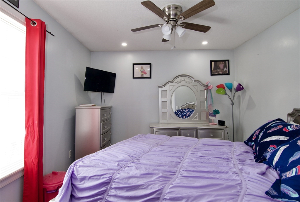 35 Anniversary Street Springfield, MA 01104 - Photo 32 of 37 a bedroom with a bed and a flat screen tv