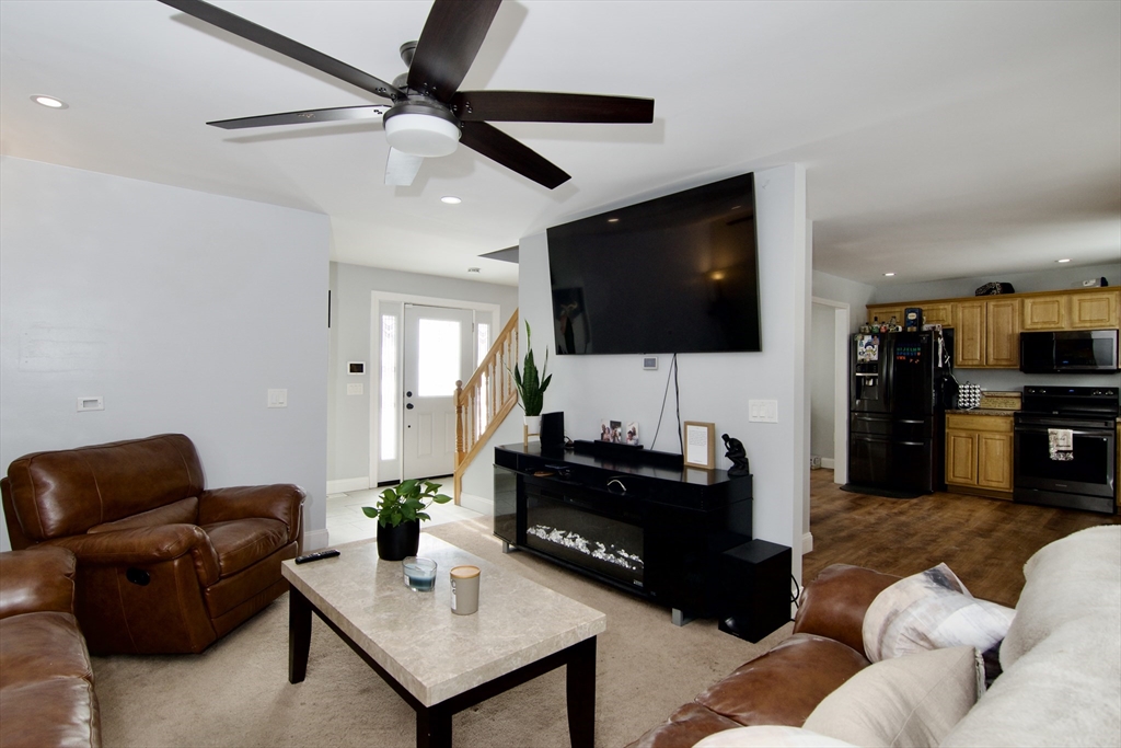 35 Anniversary Street Springfield, MA 01104 - Photo 6 of 37 a living room with furniture and a flat screen tv