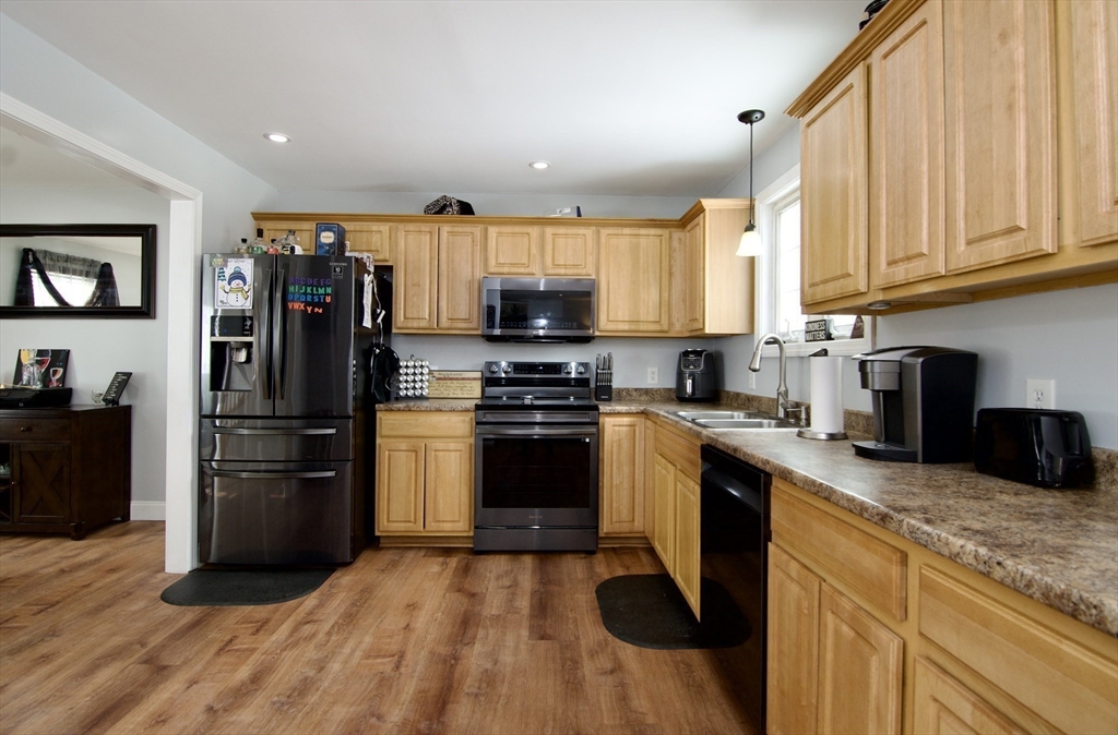 35 Anniversary Street Springfield, MA 01104 - Photo 9 of 37 a kitchen with granite countertop a refrigerator stove and microwave