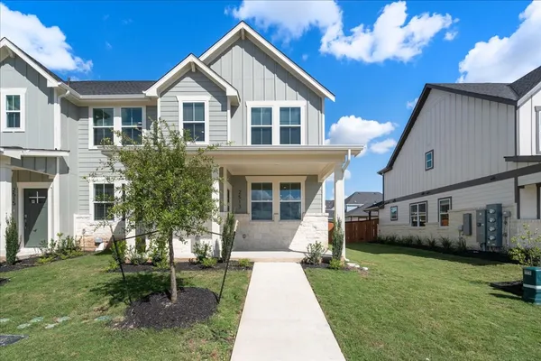 a front view of a house with a yard and porch