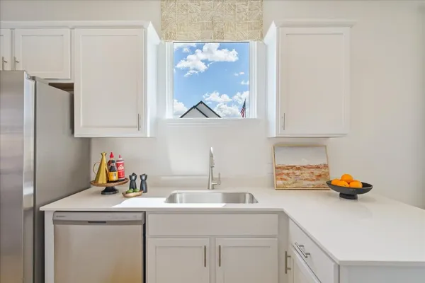 a kitchen with stainless steel appliances granite countertop a sink stove and cabinets