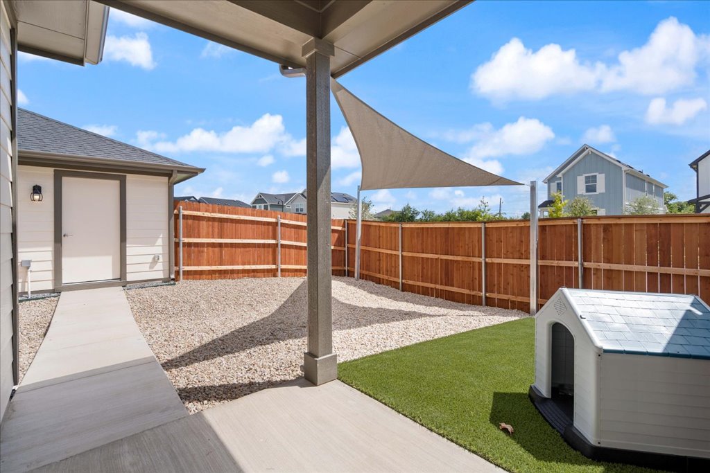 2513 Caleb Asher Loop Round Rock, TX 78665 - Photo 17 of 40 a view of a backyard with couches floor to ceiling window and potted plants