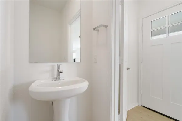 a bathroom with a sink a mirror and shower