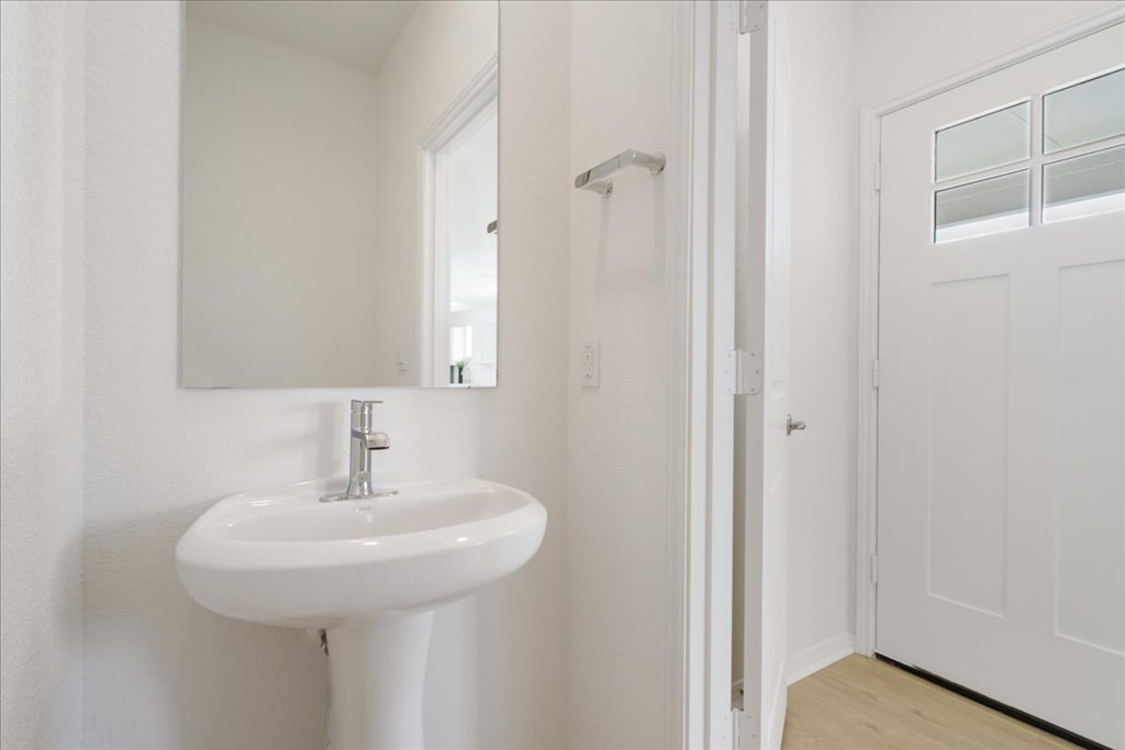 2513 Caleb Asher Loop Round Rock, TX 78665 - Photo 34 of 40 a bathroom with a sink a mirror and shower