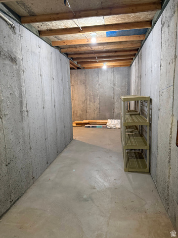 2388 East 850 South Springville, UT 84663 - Photo 45 of 58 Concrete flooring and walls, exposed wood ceiling joists, and overhead lighting