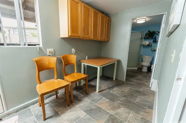a group of blue chairs sitting in a bathroom next to a window