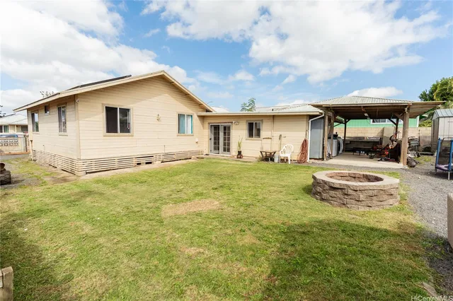 a view of a house with a yard and sitting area