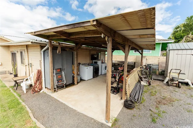 a backyard of a house with table and chairs