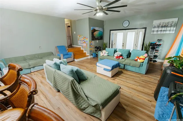 a living room with furniture and a chandelier