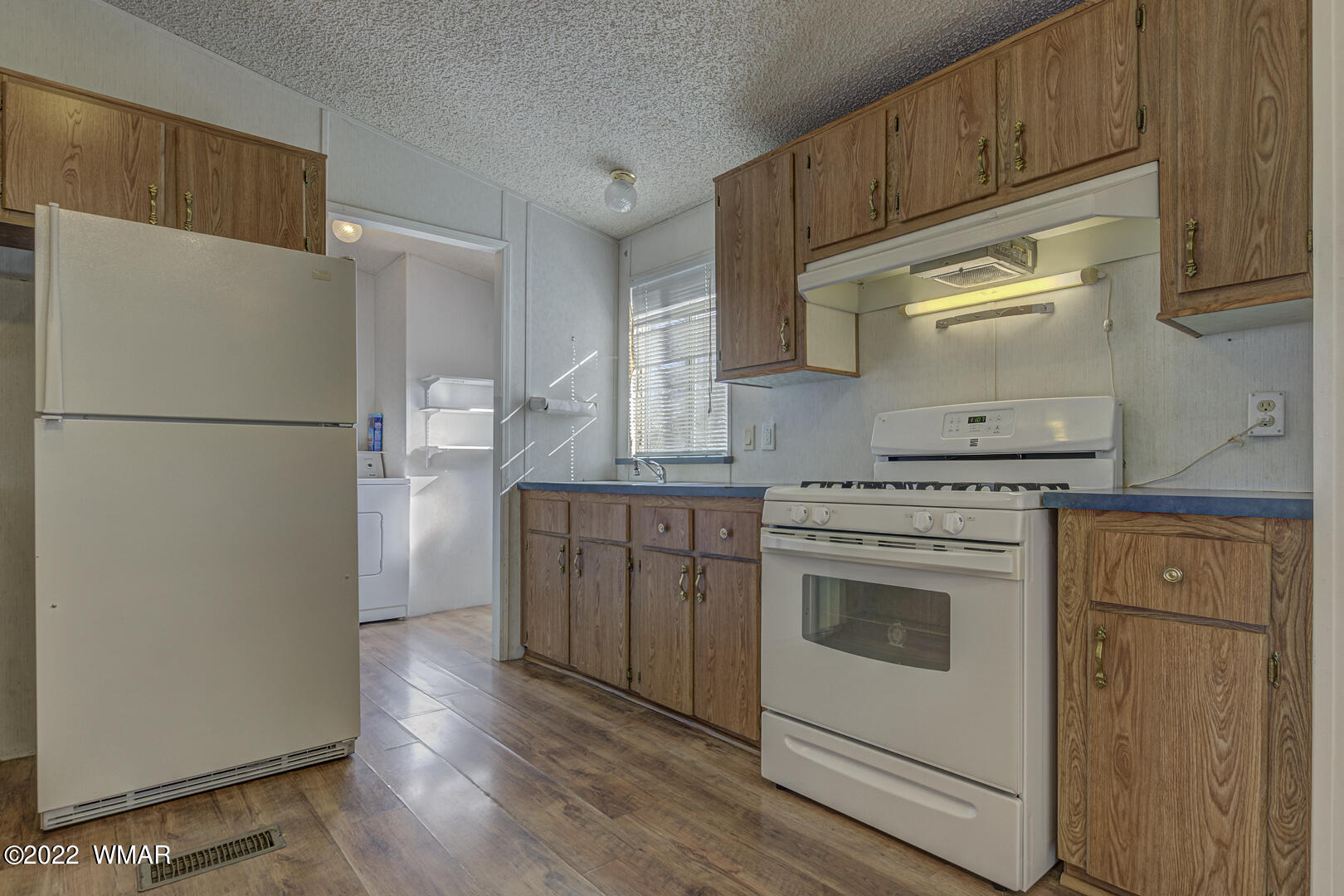 313 South Clark Road Payson, AZ 85541 - Photo 10 of 27 a kitchen with a refrigerator sink stove and cabinets