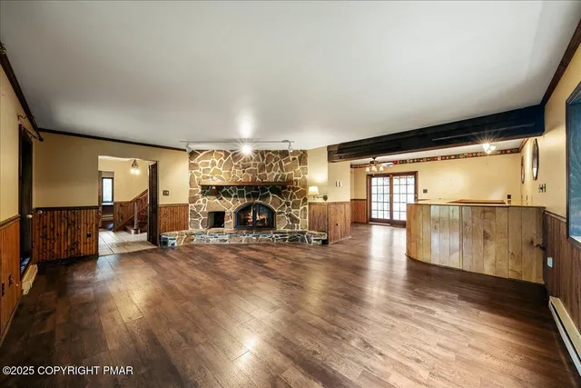 a view of a hallway view with wooden floor and staircase