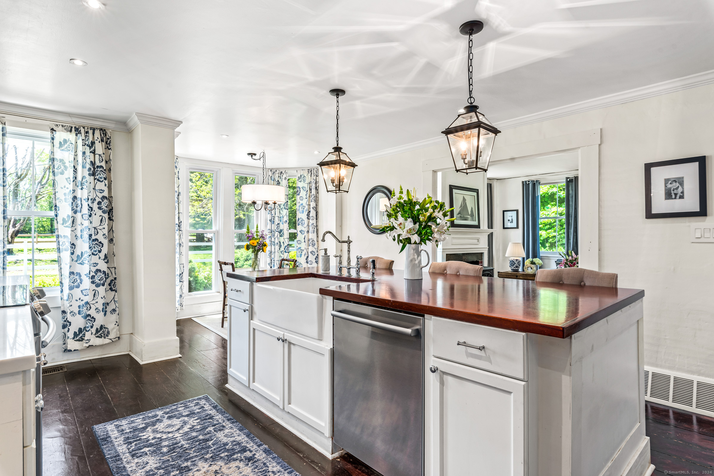 402 Perrin Road Woodstock, CT 06281 - Photo 15 of 40 a kitchen with kitchen island granite countertop a sink a stove and a chandelier