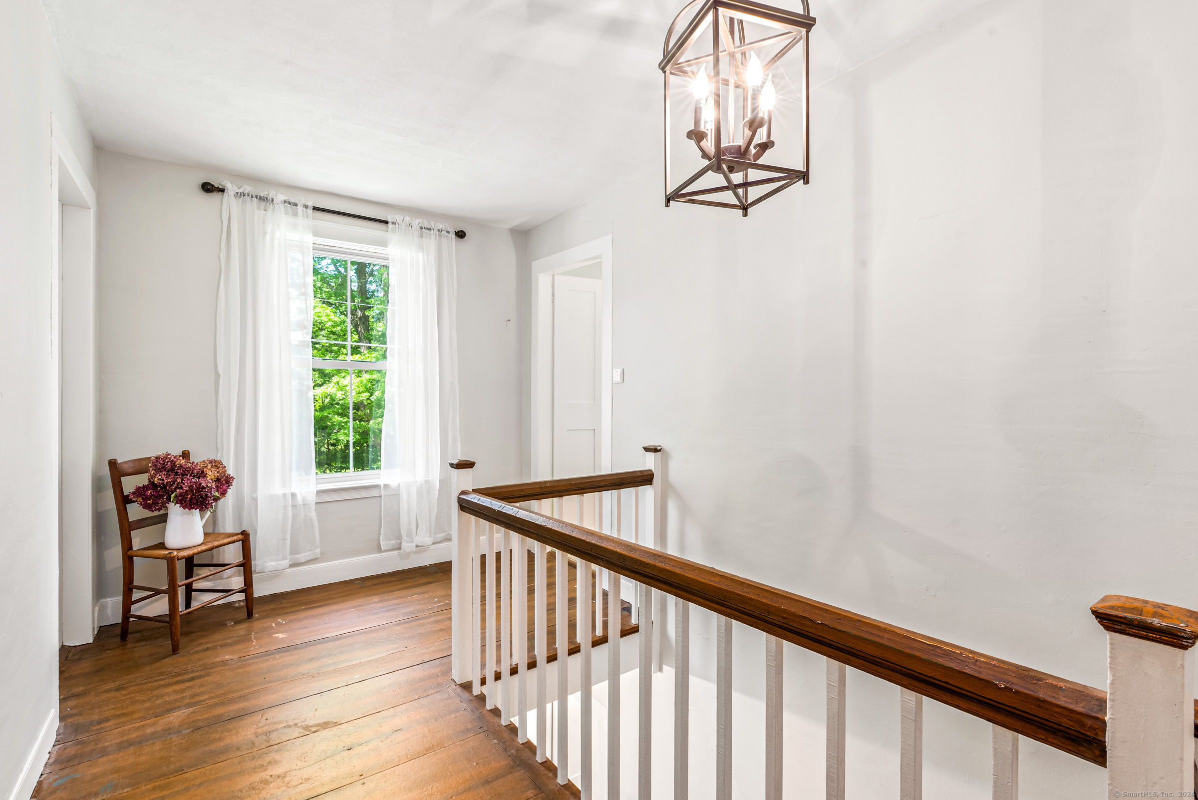 402 Perrin Road Woodstock, CT 06281 - Photo 21 of 40 a view of hallway with windows and wooden floor