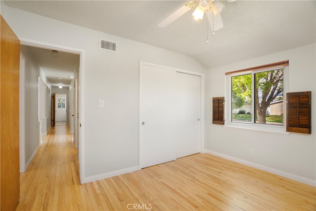 19738 Gresham Street Northridge, CA 91324 - Photo 12 of 35 a view of an empty room with wooden floor and a window