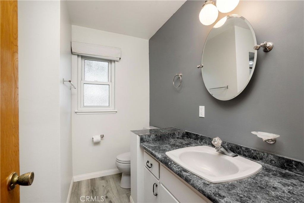 19738 Gresham Street Northridge, CA 91324 - Photo 16 of 35 a bathroom with a granite countertop sink and a mirror