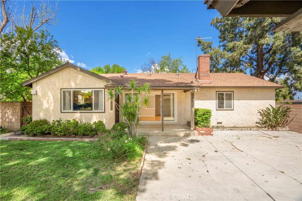 19738 Gresham Street Northridge, CA 91324 - Photo 22 of 35 a front view of a house with a garden and yard