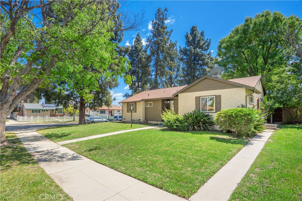 19738 Gresham Street Northridge, CA 91324 - Photo 25 of 35 a front view of a house with a yard