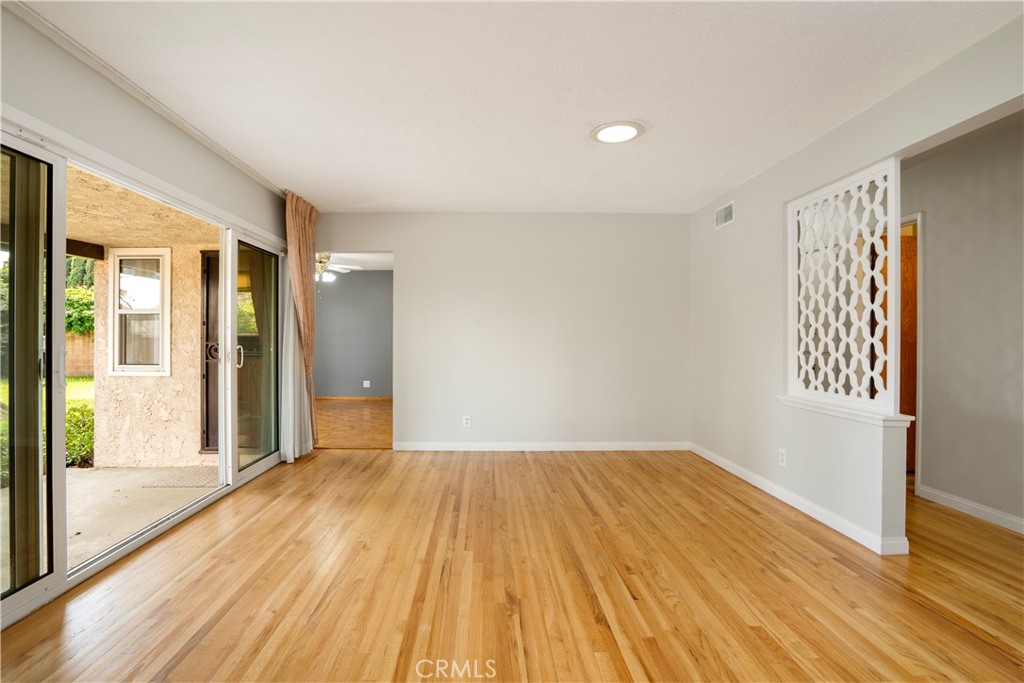 19738 Gresham Street Northridge, CA 91324 - Photo 3 of 35 a view of empty room with wooden floor and fan