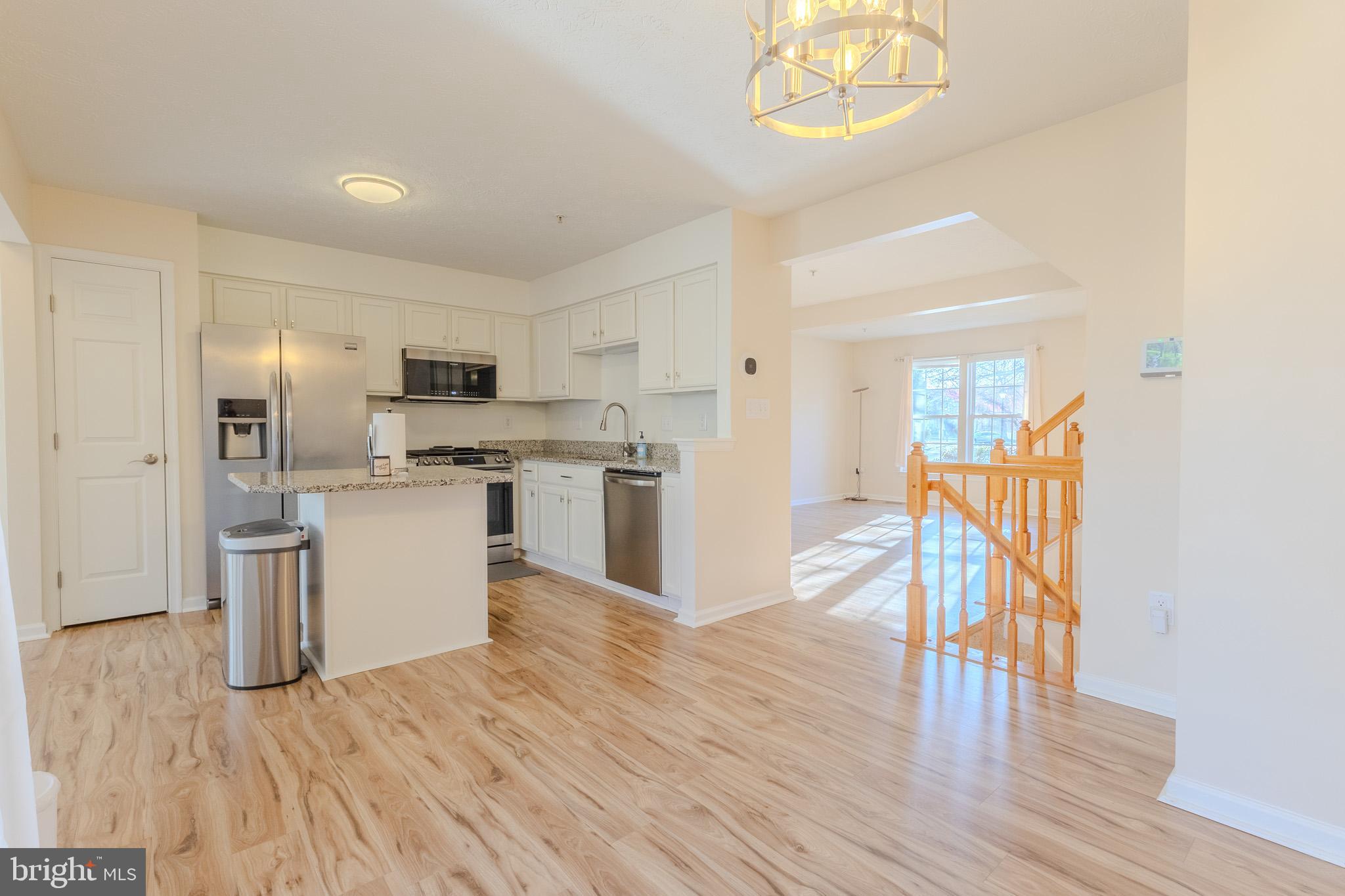 2437 High Brandy Way Odenton, MD 21113 - Photo 11 of 47 a view of open kitchen with wooden floor and electronic appliances
