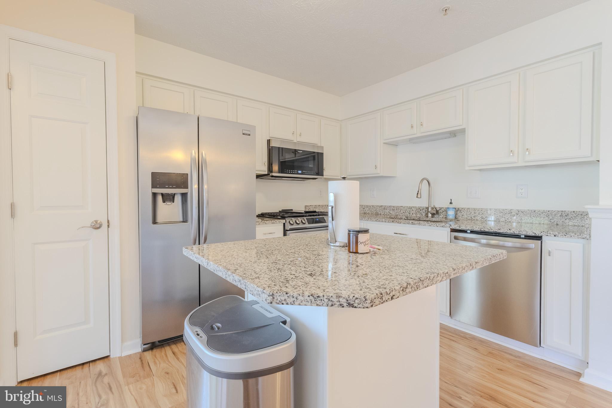 2437 High Brandy Way Odenton, MD 21113 - Photo 13 of 47 a kitchen with stainless steel appliances granite countertop a sink stove and refrigerator
