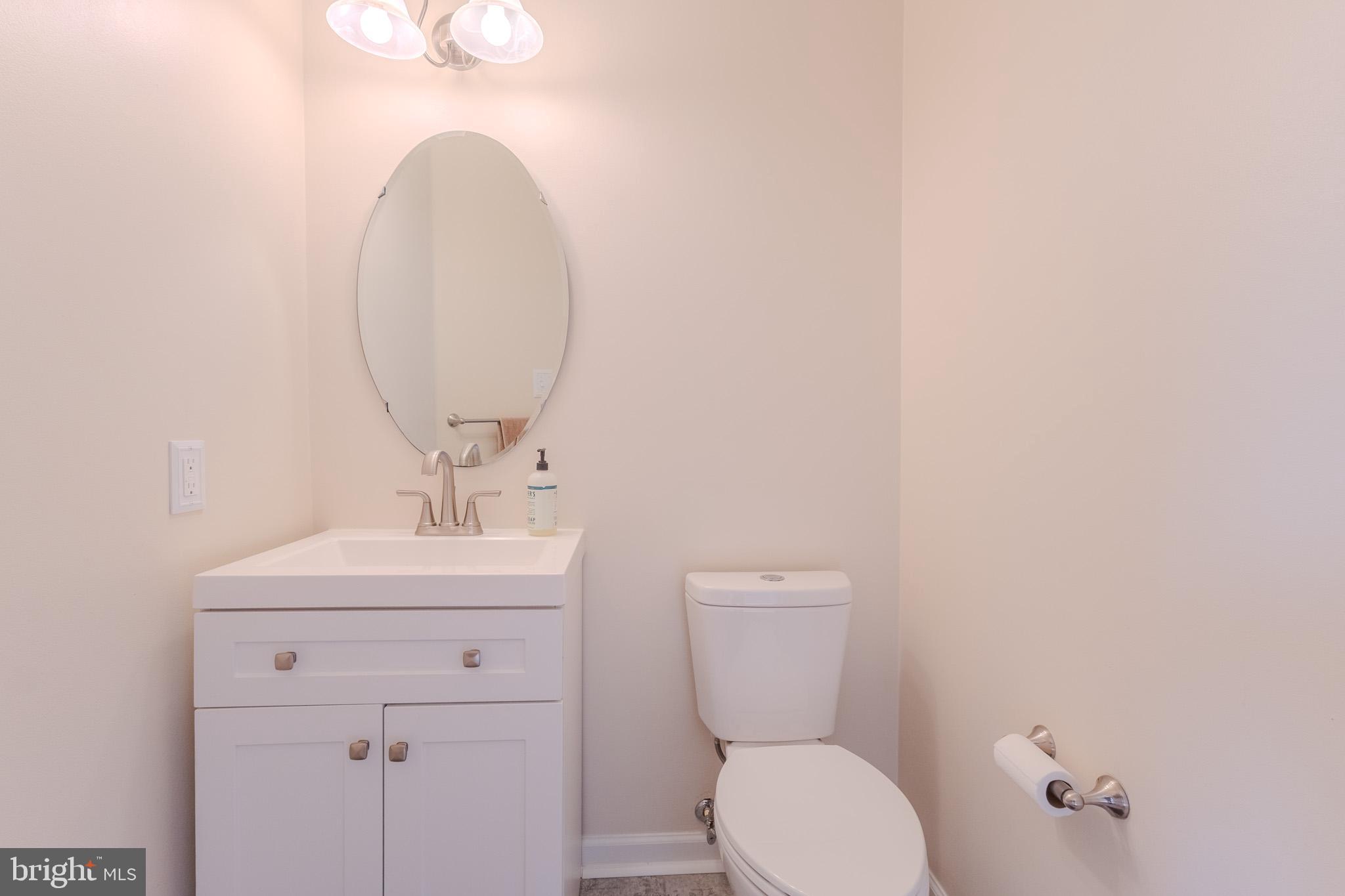 2437 High Brandy Way Odenton, MD 21113 - Photo 8 of 47 a bathroom with a toilet a sink and mirror