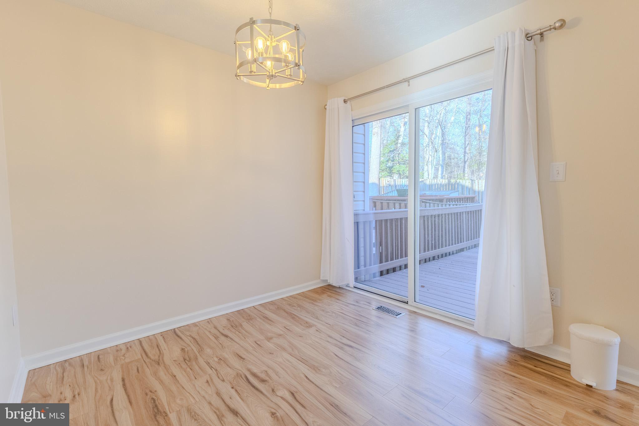 2437 High Brandy Way Odenton, MD 21113 - Photo 9 of 47 an empty room with wooden floor and door