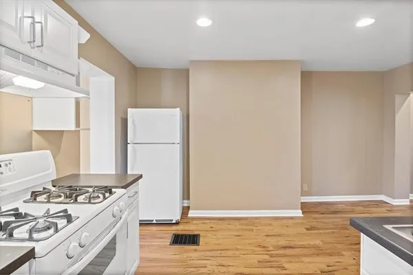 a kitchen with cabinets appliances and a window