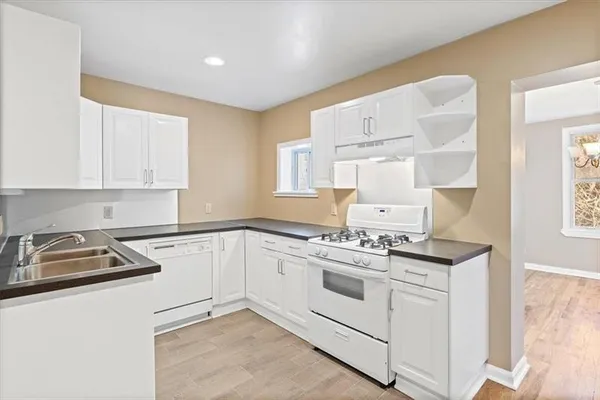 a view of a kitchen with wooden floor