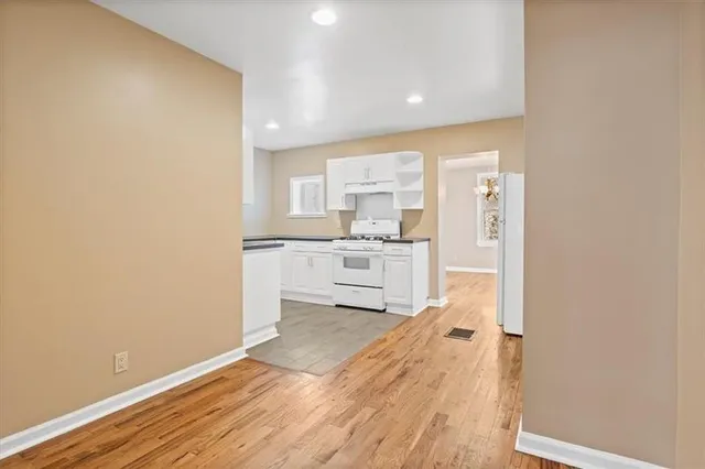 a view of a chandelier fan and wooden floor