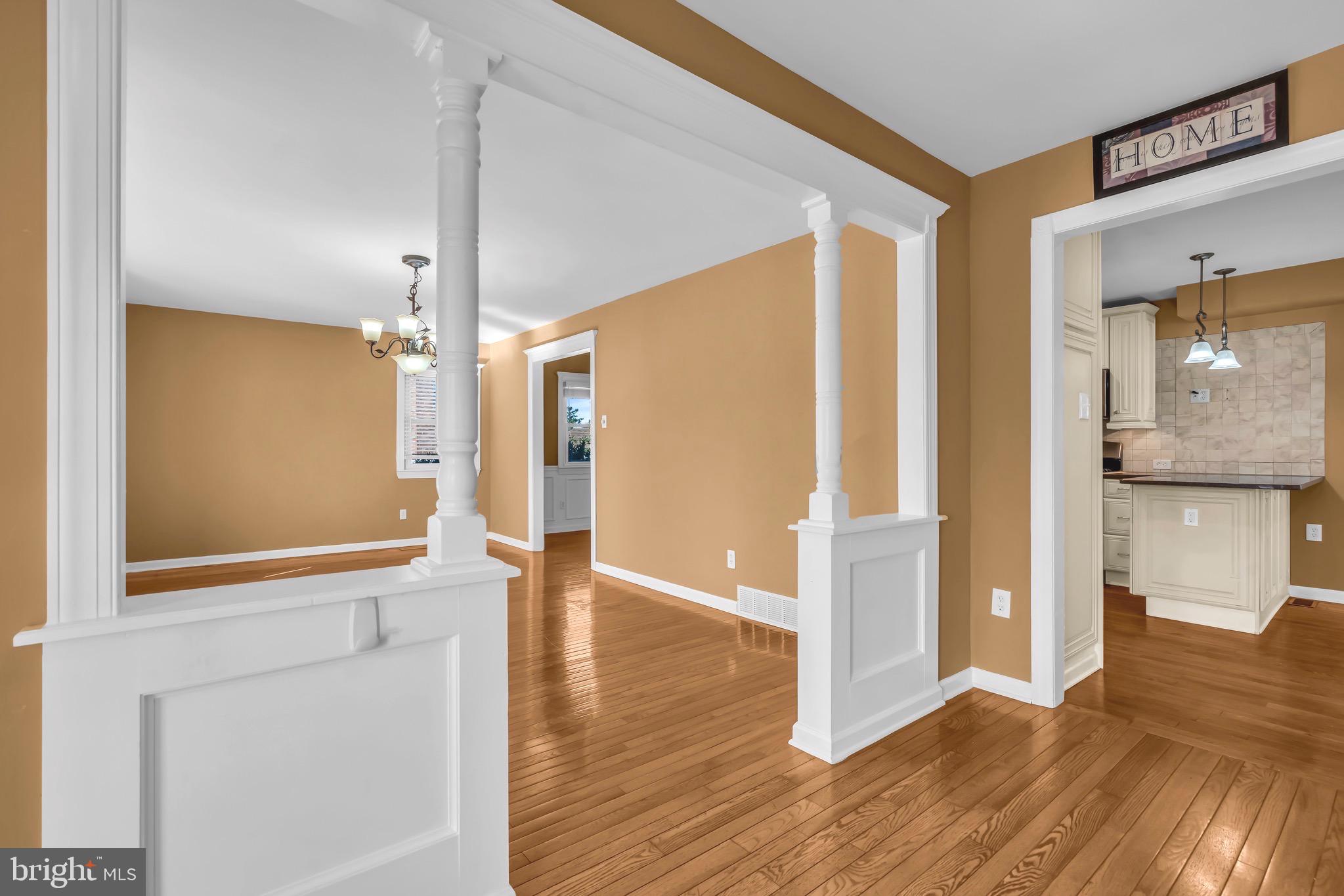721 Rancocas Avenue Riverside, NJ 08075 - Photo 4 of 56 a view of an empty room with wooden floor and a kitchen