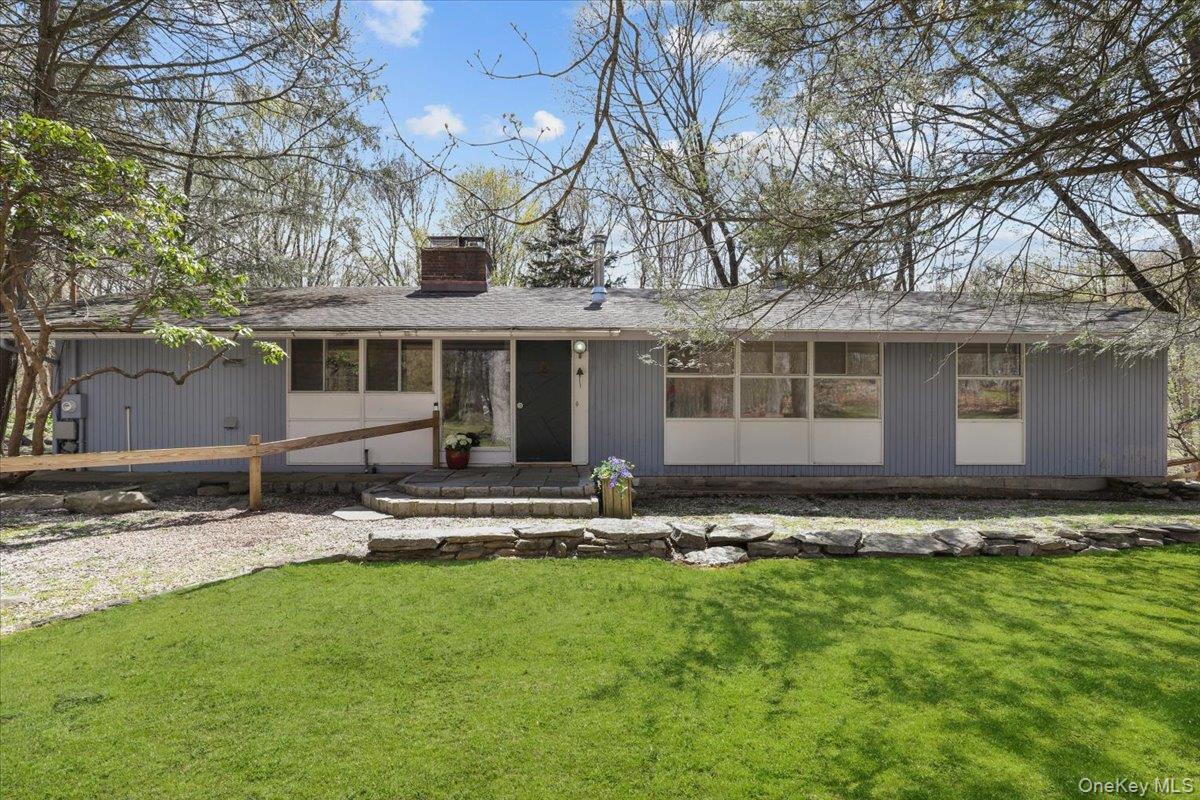 9 Cradle Rock Road East Pound Ridge, NY 10576 - Photo 1 of 1 Front of the house with stone wall and flat front yard