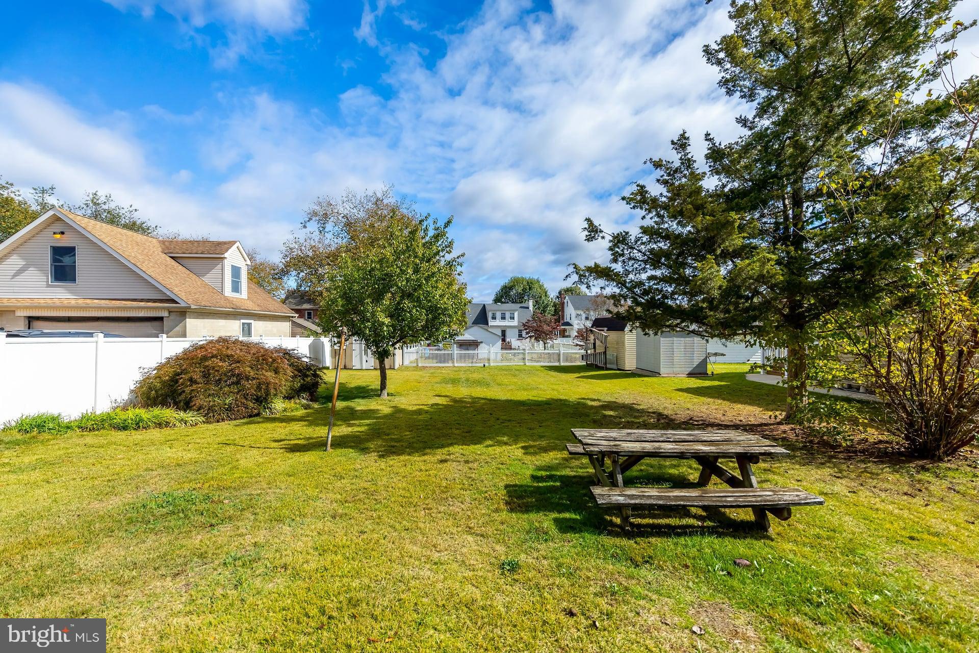 132 Tomlin Road Gibbstown, NJ 08027 - Photo 3 of 18 a view of a swimming pool with lawn chairs and plants