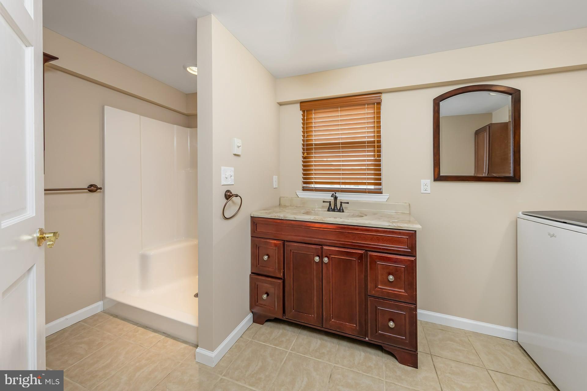 132 Tomlin Road Gibbstown, NJ 08027 - Photo 8 of 18 a spacious bathroom with a granite countertop sink a mirror and a bathtub