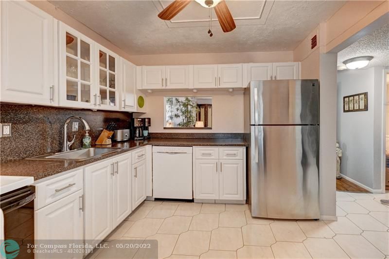 a kitchen with appliances cabinets and a sink