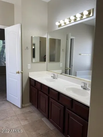 a bathroom with a double vanity sink and a mirror