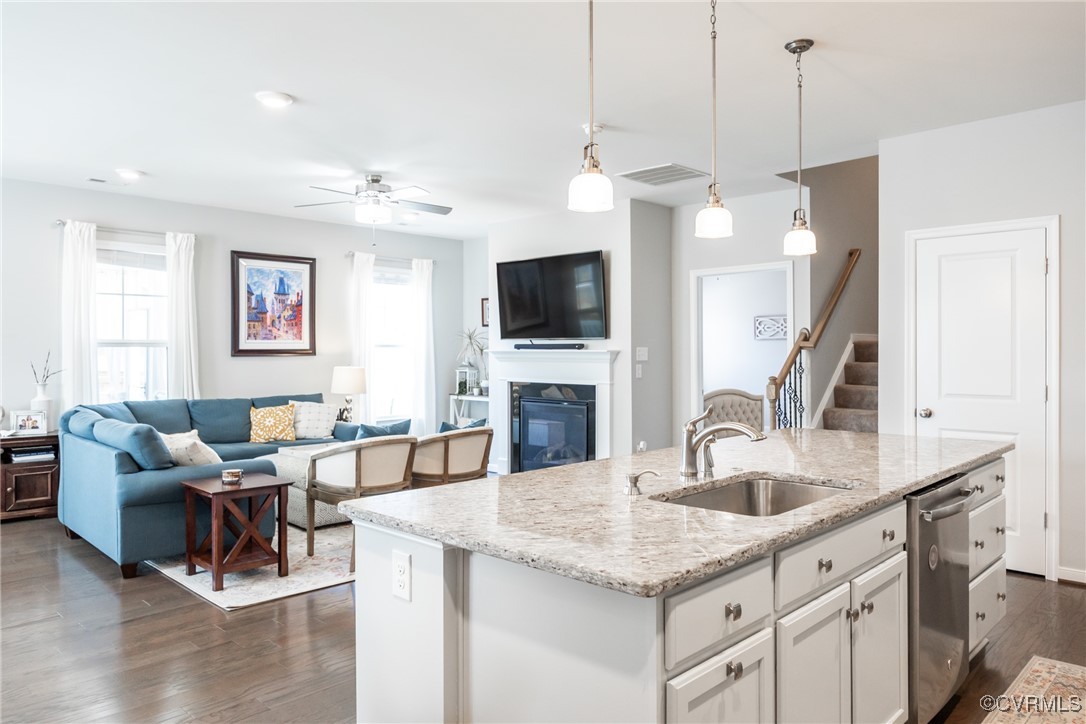 4143 Cambrian Circle Midlothian, VA 23112 - Photo 11 of 37 a kitchen with granite countertop a sink a counter top space and living room view