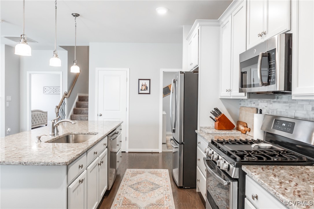 4143 Cambrian Circle Midlothian, VA 23112 - Photo 8 of 37 a kitchen with granite countertop a sink stove and refrigerator