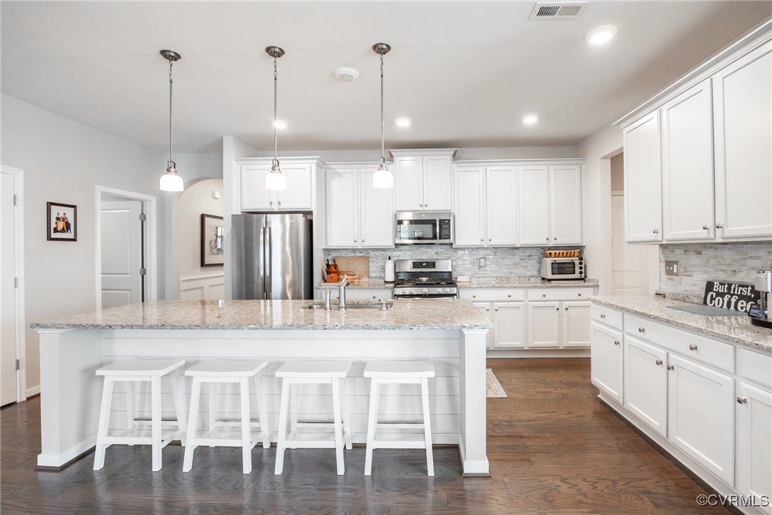 4143 Cambrian Circle Midlothian, VA 23112 - Photo 9 of 37 a kitchen with stainless steel appliances kitchen island granite countertop a table chairs sink and cabinets
