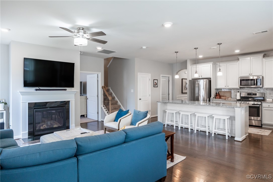 4143 Cambrian Circle Midlothian, VA 23112 - Photo 10 of 37 a living room with furniture a flat screen tv and a fireplace