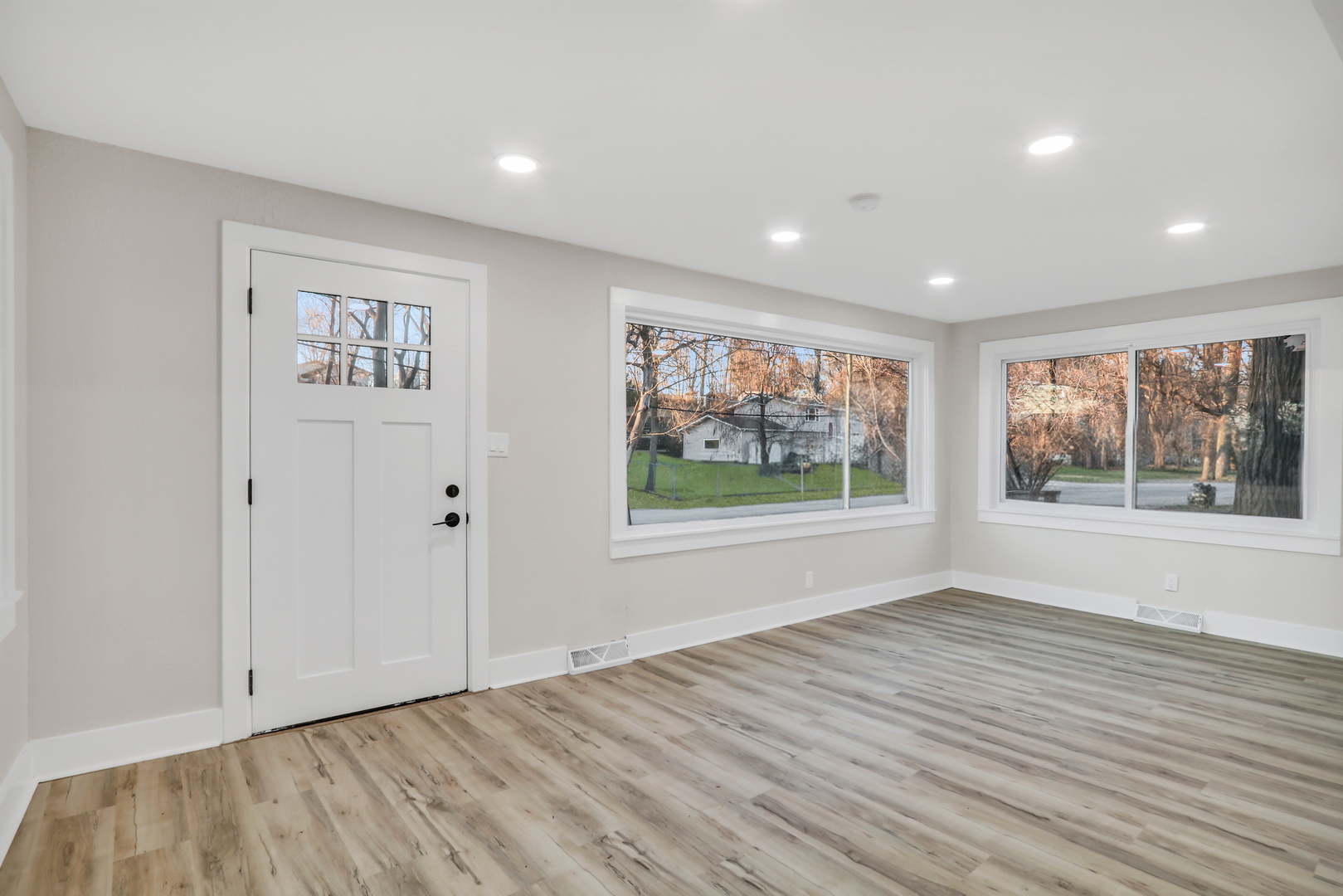 38323 North 3rd Avenue Spring Grove, IL 60081 - Photo 3 of 27 a view of an empty room with wooden floor and a window