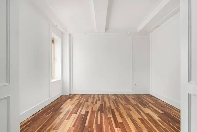 a view of a room with wooden floor and closet
