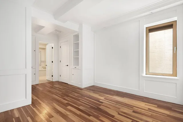 a view of a room with wooden floor and window