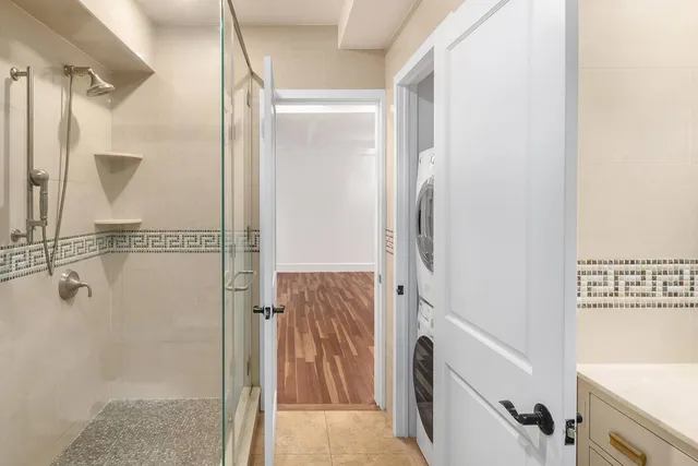 a bathroom with a glass shower door and mirror